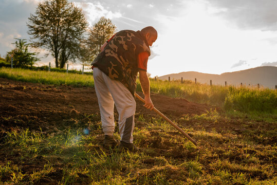 Farmer working on an agricultural fields in spring.