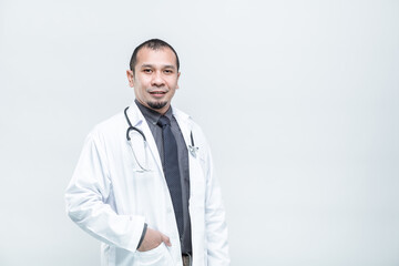 Health care, Portrait of cheerful smiling man doctor with arms crossed on white background.