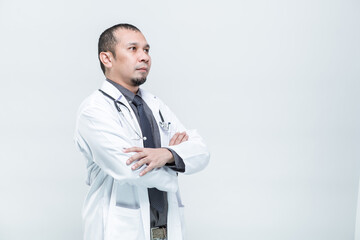 Health care, Portrait of cheerful smiling man doctor with arms crossed on white background.