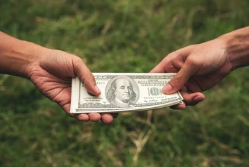 Fotobehang Close up hands giving money bribe payment. Hands holding dollar bill bribery financial economy business people. Business people corrupt illegal settlements try to pay graft. Corruption bribe concept © aFotostock