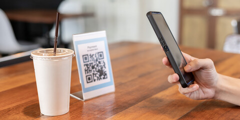 Woman use smartphone to scan QR code for order menu in cafe restaurant with a digital delivery. Choose menu and order accumulate discount. E wallet, technology, pay online, credit card, bank app.