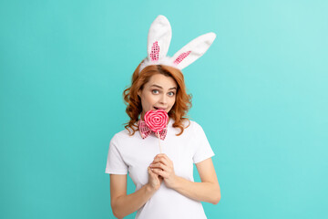 happy easter girl wear rabbit ears hold heart lollipop