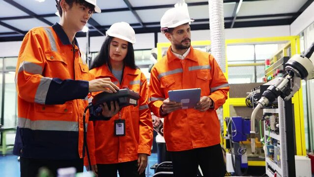 Team male and female robot engineering students at the robot development Institute studies and researches the operation robot arms support modern industries that use remote controlled robot machinery.