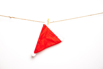Red Santa cap is hanging on isolated white background