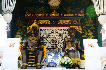 Mangrai King of Lanna Kingdom ancient statue and Queen of Mengrai King antique monument for thai people traveler travel visit praying respect blessing at Wat Ming Mueang temple in Chiang Rai, Thailand