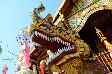 Carving sculpture ancient naga or antique naka statue for thai people travelers travel visit respect praying blessing wish myth holy mystery mystical at Wat Ming Mueang temple in Chiang Rai, Thailand