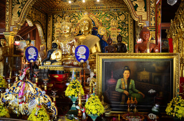 Ancient buddha in antique ubosot of Wat Ming Mueang temple for thai people traveler visit respect praying blessing wish myth holy mystical at Chiangrai city on February 24, 2015 in Chiang Rai Thailand