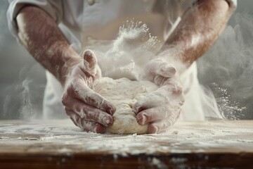 Close-up of a man's hands kneading dough on a light background