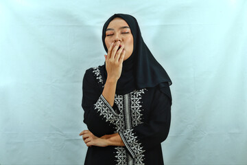 beautiful young Asian Muslim woman wearing hijab and black dress with white pattern covering his...