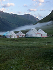 View of houses and forests in the morning mist