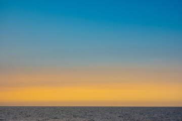Fototapeta premium skyline view The sun sets in the evening sky with colorful clouds. and beautiful cloud patterns In the soft light Evening at the sea 