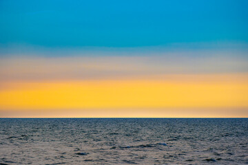 Fototapeta premium skyline view The sun sets in the evening sky with colorful clouds. and beautiful cloud patterns In the soft light Evening at the sea 