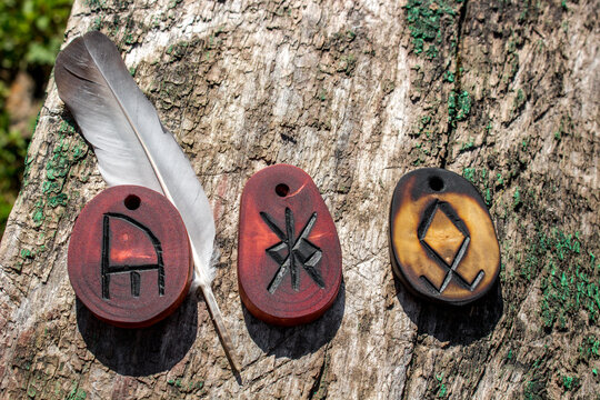 A set of talismans of three runes - Odal (Othala), Yr (bow) and double Calc (chalice). Anglo-Saxon futhark (futhorc)