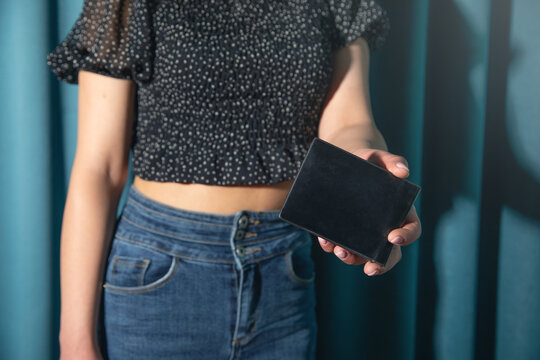 Young woman showing wallet. Fashion