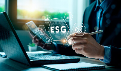 ESG environment social governance investment concept. Businessman using computer to analyze...