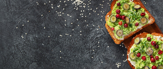 Vegan toast with avocado,mushroom and fresh salad on dark background. Vegetarian food concept