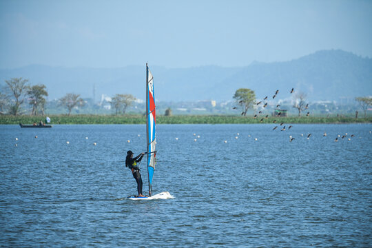 wind surfing at Deepor beel Guwahati on occasion of Rising sun water sport organized by the Indian army.  Deepor beel is a home for many migrated birds from different parts of the world. 