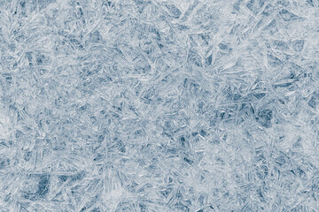 Ice texture crystal, blue tones background. Textured cold frosty surface of ice.