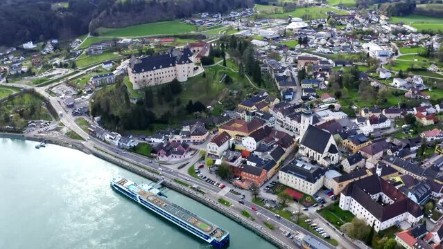 Beautiful drone shot of the village "Grein" in austria. Aerial footage of castle by danube river. 4k UHD