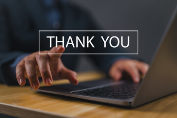 businessman using a laptop sends the message thank you on a display screen. concept of thank you business, appreciation and gratitude, congratulations, presentation from technology digital