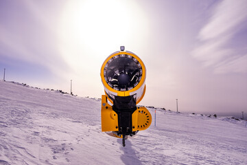 Snow cannon on a ski slope