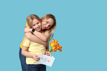 Cute little girl with her mom, festive postcard and bouquet for Mother's Day hugging on blue...