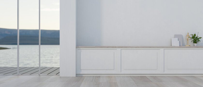 The interior design showcases a modern, white, empty room featuring a wall with white moulding.