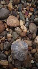 abstract Textured background with round pebble stones. Vacation holiday recreation on beach concept. High quality photo. Fragment with a texture of rock. surface  stone wall with cracks.