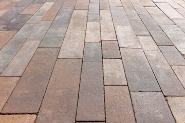 Paving slabs of rectangular elongated shape of different sizes and colors. Angled view.