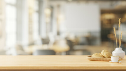 A space on a wooden tabletop with a blurred background of a contemporary coffee shop.