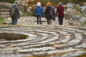 retreat attendees walking a stone labyrinth in silence - obrazy, fototapety, plakaty