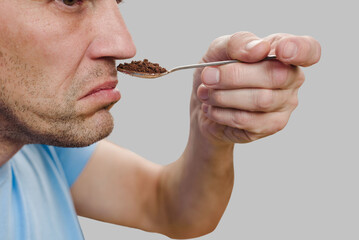 Sick young man trying to sense smell of fresh coffee. Savoring memories: Loss expressed as man...
