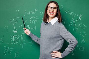 Young teacher woman she wear grey casual shirt glasses hold pointer indicate on formula look camera...