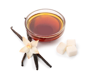 Bowl of vanilla extract, sticks and sugar on white background