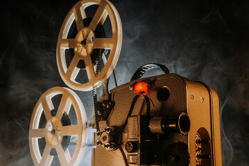 Obsolete film projector, retro home theatre entertainment. Nostalgia, memories - obrazy, fototapety, plakaty