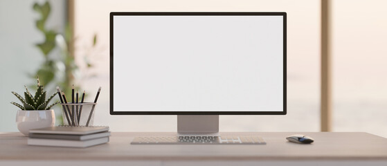 A front view image of a PC computer white-screen mockup on a desk in a modern bright office. - obrazy, fototapety, plakaty