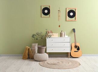 Interior of living room with wind chime, guitar and commode