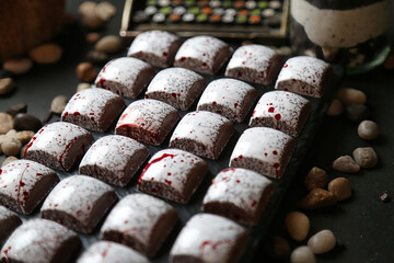 Abundant Display of Brownies With White Frosting on a Table