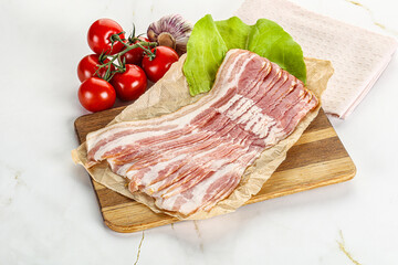 Sliced pork bacon oved board