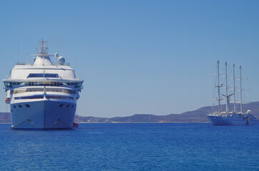Small classic luxury cruiseship cruise ship liner yacht anchoring on Aegean blue sea in front of...