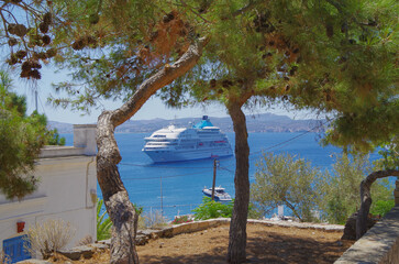 Small classic luxury cruiseship cruise ship liner yacht anchoring on Aegean blue sea in front of...