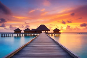 Papier Peint photo Orange Wooden jetty at sunset in tropical  island with water bungalows An amazing sunset landscape Picturesque summer sunset , Ai generated