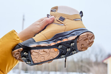 Ice grips for walking on icy or slippery surfaces, traction tread outsole and cleats simultaneously contact walking surface, providing superior grip on ice, snow, and pavement.