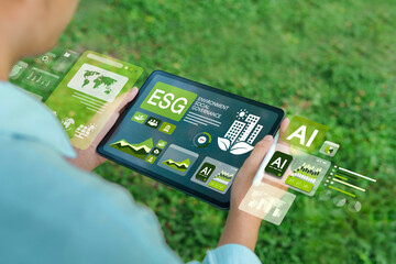 ESG concepts for environment, society and governance. Businessman uses iPad to analyze ESG in...