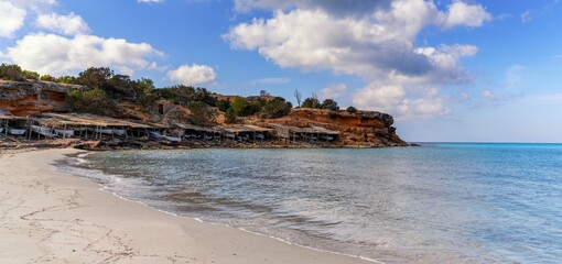 old fishing huts and boat garages at the Cala Saona beach and cove on Formentera Island