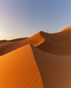 view of the sand dunes at Erg Chebbi in Morocco in warm evening light