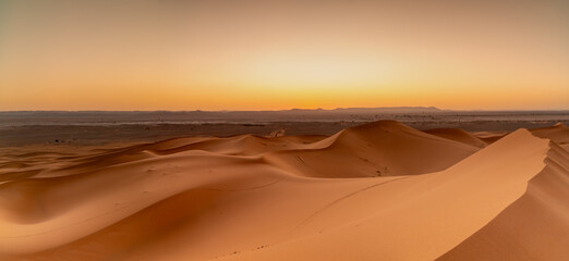 view of the sand dunes at Erg Chebbi in Morocco at sunset