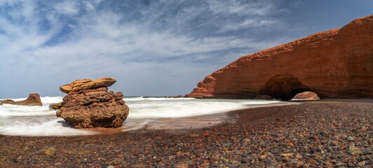 panorama landscape view of the beach and rock arch at Legzira on the Atlantic Coast of Morocco