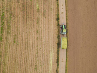 Aerial view of a tractor with a trailer in the countryside 