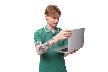 young smart successful student european man with red hair holding a laptop